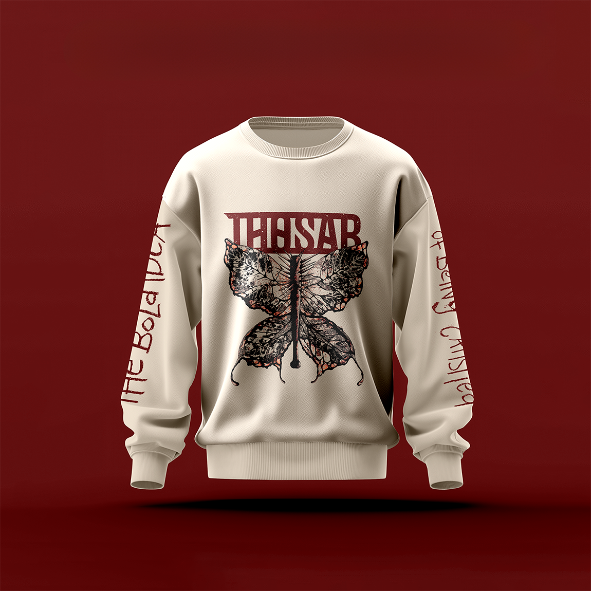 Beiges Sweatshirt mit rostrotem Thosar-Logo, darunter ein Schmetterling. Auf den Ärmeln der Text "The Bold Idea Of Being Satisfied"