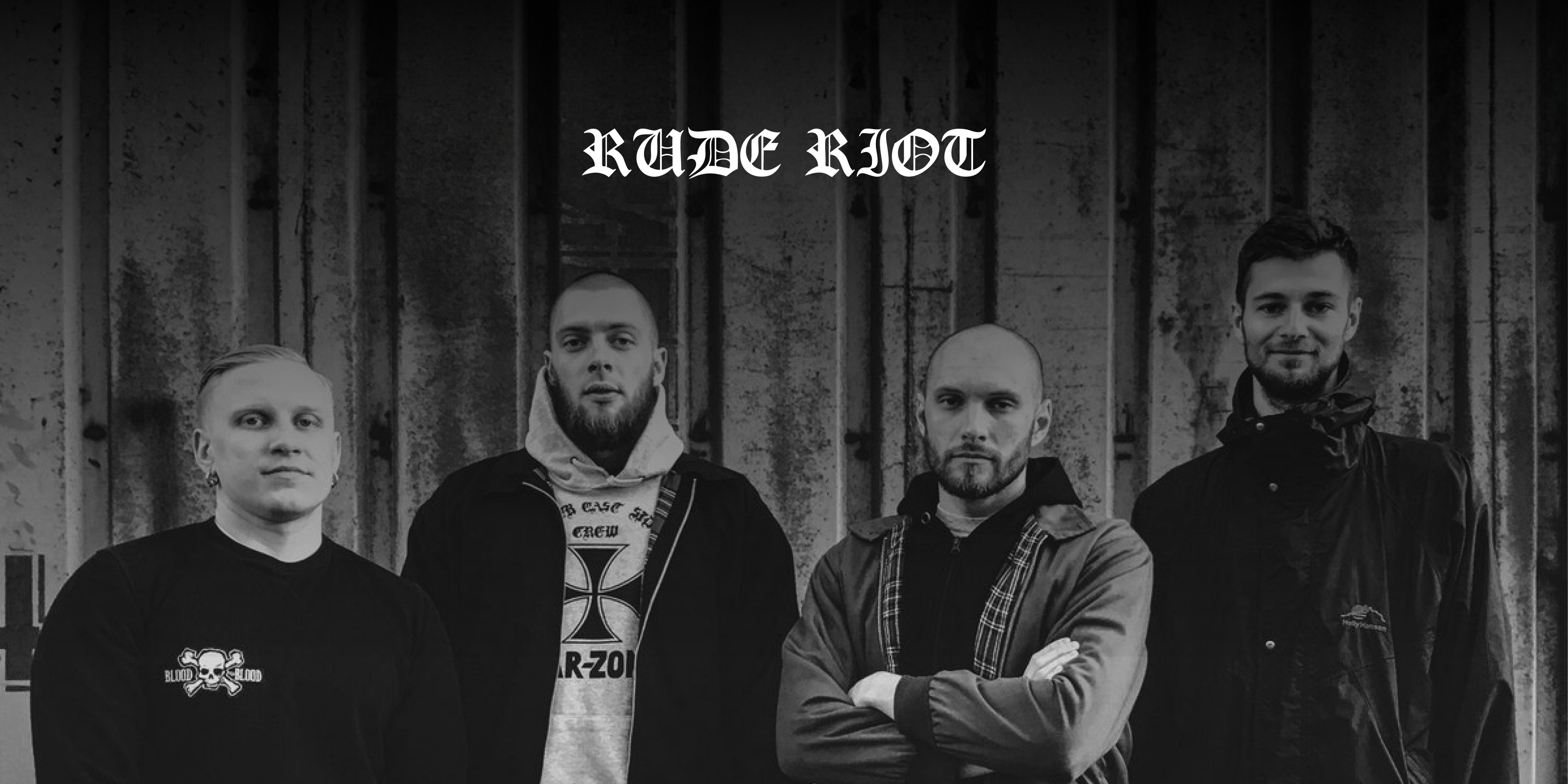 Die Band "Rude Riot". Vier Personen stehen vor einer Mauer, blicken in die Kamera.